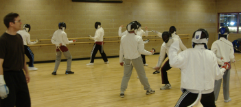 Photo of fencers with instructor